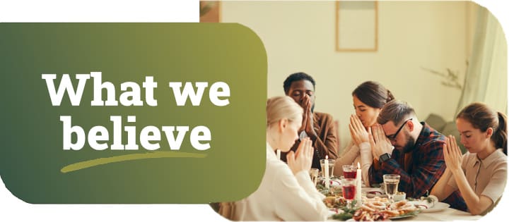 What we believe. Family praying before a big dinner