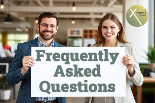 Two digital freelancers holding up a sign saying "Frequently Asked Questions" in a San Antonio website design studio