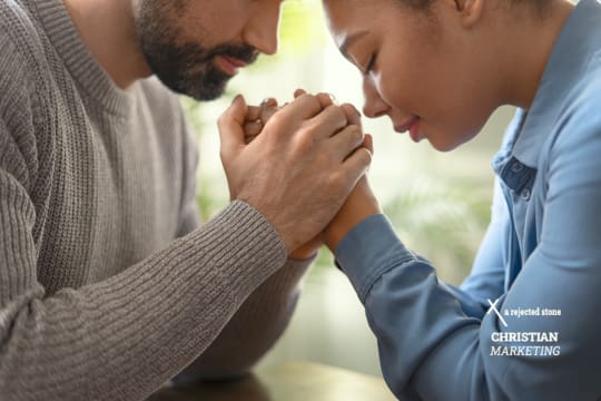 Man praying and sharing his faith with a woman