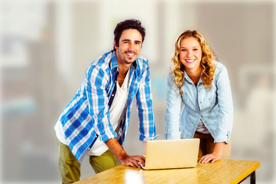 Young business couple smiling in office