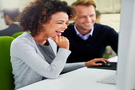 Two coworkers thrilled with the SEO results provided by a rejected stone