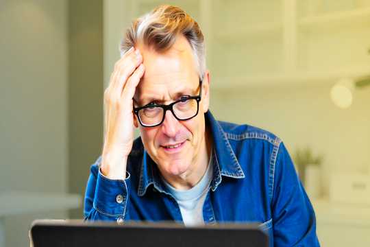 Middle aged man reading computer screen